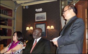 Yuan Xiaohona, host Mayor Mike Bell, and Wu King Hung listen to a translation of remarks by Mr. Wu at a dinner at Real Seafood in October during which ties were strengthened.