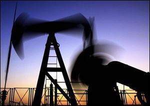 An oil rig works in the desert oil field of Sakhir, Bahrain. 