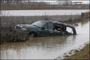 A green SUV is stuck in a water swollen ditch on southbound I-75 just south of State Rt. 613. According to The Ohio Highway Patrol, the driver hydroplaned off of the road into the ditch at about 4 a.m. Monday.  No one was seriously injured.