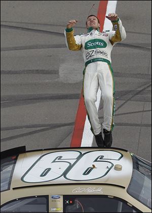 Carl Edwards does a backflip off the side of his car to celebrate his victory.