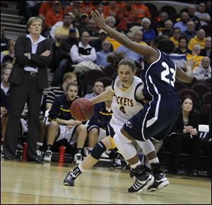 UT's Naama Shafir drives around Akron's Jasmine Mushington Wednesday in the Rockets' MAC quarterfinal win at Cleveland. Shafir had 28 points.