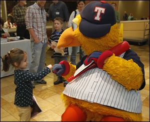 Ava Grose, 4, of Marblehead, Ohio, bumps fists with Muddy the Mud Hen at the Kidney Foundation of Northwest Ohio's free health screenings at Westfield Franklin Park mall's food court. The event from 1 to 3 p.m. yesterday was made possible by volunteers from Leadership Toledo. 