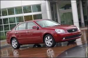  Kia Motors is recalling more than 70,000 Optima midsize sedans to fix transmission problems that can cause the cars to roll even while they're in park. 