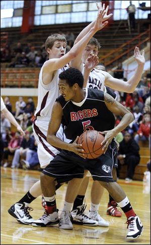 Markeith Douglas of Rogers, a 6-1 senior, looks to pass against Rocky River in a Division II regional semifi nal.