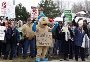 At the University of Toledo Lake Erie Center in Oregon, protesters greet Governor Kasich with jeers and chants of ‘Kill the bill,’ a reference to Senate Bill 5, which aims to limit collective-bargaining rights.