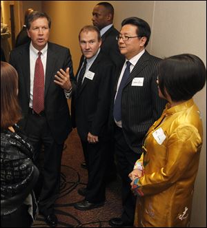 Governor Kasich, left, meets with, from left, Scott Prephan of North Pacific Connections; Simon Guo, a deal broker between Chinese and U.S. businessmen, and Yuan Xiaohona, a Chinese investor, before his speech to the Wood County Economic Development Commission.