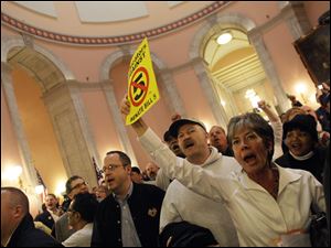 Protesters gather in the rotunda at the Ohio statehouse after Senate Bill 5 passed through the Ohio on Wednesday