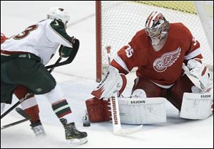 Red Wings goalie Jimmy Howard (35) stops a shot from Wild left wing Eric Nystrom (23) in the third period.