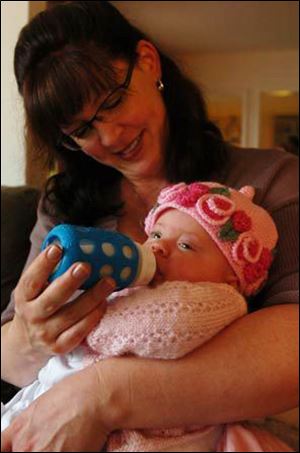 Stephanie Lovell-Rose of El Cerrito, Calif., gives her daughter a bottle of breast milk from an area milk bank.