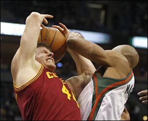 Cleveland's Luke Harangody, left, and Milwaukee's Corey Maggette vie for a rebound.