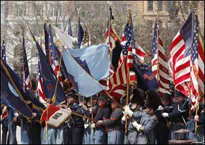 Re-enactors beat the drums in Columbus. The first regiment to fight in a Civil War battle was the 14th, and was from the Toledo area.