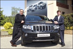 Fiat and Chrysler CEO Sergio Marchionne, left, and Jeep brand CEO Mike Manley show off a Grand Cherokee in northern Italy ahead of a European launch.