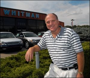 Jon Whitman, in a 2005 file photo, said he is closing Whitman Ford because of his frustration with a costly rezoning battle with Bedford Township.