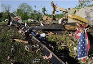 The wreckage of two mobile homes lies twisted on the ground Saturday in the Boone's Chapel in Autauga County, Ala., after severe winds hit late Friday night, leaving three people in the area dead. 