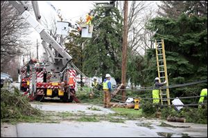 Edison crews work on power lines along Bryan Road in Oregon that were damaged by the tornado rated at EF-0 on the Fujita scale. Winds were estimated at between 65 and 85 hours per hour. 