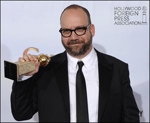 Paul Giamatti holds the award he won for best performance in a comedy or musical for his role in 