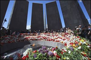 Armenians lay flowers at a memorial to Armenians killed by the Ottoman Turks, as they mark the 96th anniversary of the mass killings.