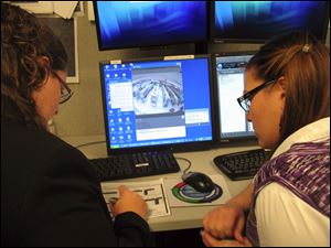 Two members of Target's investigations team study loss statistics at the Ellicott City, Md., anti-theft center.