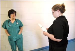 Part-time veterinarian Cindy Thurston, left, and Dog Warden Julie Lyle discus a dog that has recently arrived at the pound and suffers from seizures. Right now, the warden's part-time veterinarian works three days a week. Among the changes Ms. Lyle is planning to make soon is to hire a permanent full-time veterinarian for $55,105 a year.