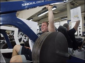 Kevin Kowalski builds strength in his left shoulder with a 180-pound press exercise. The UT senior has been working out in anticipation of this week’s NFL draft.