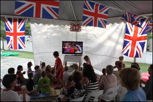 Supporters of the British royal family watch a TV screen in a suburb of Kuala Lumpur, Malaysia of the royal wedding at Westminster Abby in London of Prince William to Kate Middleton on Friday.