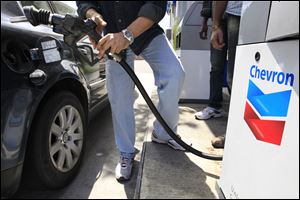 A Chevron customer pumps gas in Mountain View, Calif. 