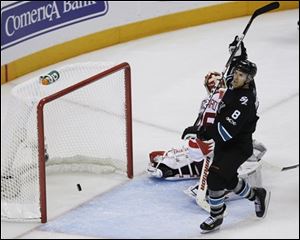 Sharks center Joe Pavelski (8) scores past Red Wings goalie Jimmy Howard (35) during the third period.