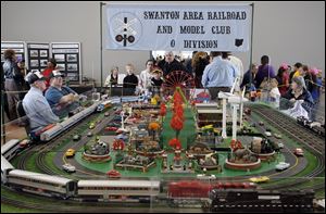 A display set up by the Swanton Model Railroad Club is a big draw at the Amtrak station near downtown Toledo for National Train Day. An Amtrak passenger train was available for tours.