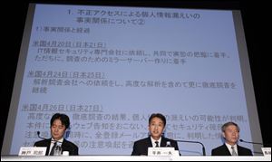 Sony Computer Entertainment President and CEO Kazuo Hirai, center, speaks as Sony Corp.'s Senior Vice Presidents Shiro Kambe, left, and Shinji Hasejima, right, listen during a press conference at the Sony Corp. headquarters in Tokyo Sunday.