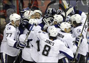 Tampa Bay Lightning's Vincent Lacavalier, second from left, celebrates his goal with the team during the overtime period in Game 2 of a conference semifinal NHL Stanley Cup hockey playoff series with the Washington Capitals Sunday. The Lightning won 3-2. 