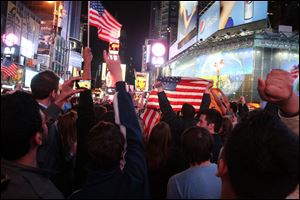 A crowd gathered in New York's Times Square reacts to the news of Osama Bin Laden's death early Monday morning.