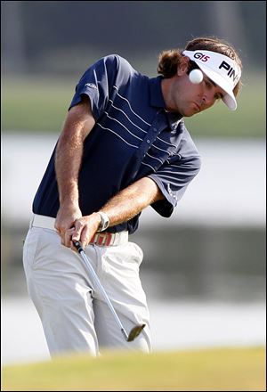 Bubba Watson chips onto the 18th green during a sudden death playoff at the Zurich Classic. 