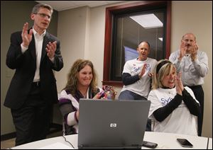 Sylvania Superintendent Brad Rieger, treasurer Laura Sauber, Adam Fineske, school board president Vicki Donovon-Lyle, and Human Resources director Jeff Robbins react to the passage of the Sylvania Schools 4.9-mill levy Tuesday night.