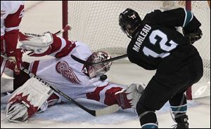 Detroit Red Wings goalie Jimmy Howard (35) blocks a shot from San Jose Sharks center Patrick Marleau (12) in the second period in Game 2 in the NHL hockey Stanley Cup playoffs Western Conference semifinal in San Jose, Calif..