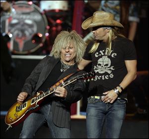 Bret Michaels, right and C.C. DeVille and the rest of the '80s metal band Poison will be at the Toledo Zoo July 28.