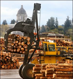 Logs for export to China are stacked at Olympia, Wash. A big jump in oil imports pushed the U.S. trade deficit higher in March.