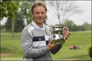 Bernhard Langer shows off his 2010 U.S. Senior Open tournament trophy at the Inverness Club. Langer will lead a field of 156 players for this year’s tourney, running July 28-31.