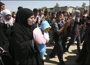 Syrians who fled violence in the villages along the Lebanese border shout slogans as they protest in the Wadi Khaled area of Lebanon, about a half-mile from the border. Refugees told of execution-style slayings and of streets littered with bodies. 