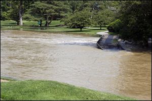 Ten Mile Creek, overflowing at the Highland Meadows Golf Club after storms in 2006, is a candidate for drainage improvement work, county engineers say. 