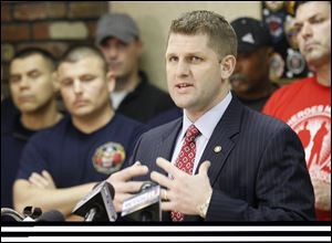 State Rep. Matt Szollosi speaks against Senate Bill 5 and Ohio Gov. John Kasich during a news conference Thursday at the Toledo Firefighters Local 92 union hall.