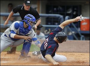 The Hens' Scott Thorman gets tagged out at home by Durham's Robinson Chirinos. The outfielder pitched an inning in the 12-3 loss.