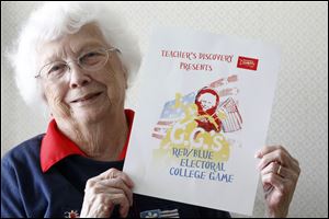 Inventor Dorothy Schabeck, 84, from Toledo, holds the rules of her game 