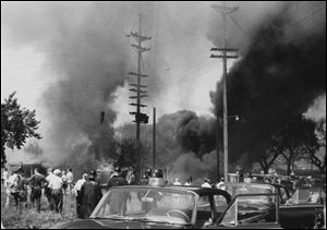 Accounts suggest that thousands of people gathered to watch the blaze. The  massive blast destroyed several nearby homes, and firefighters, police officers, and onlookers were pushed back by the heat.