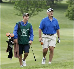 Matt Mocek, left, aids John Thomas. Mocek goes to Miami University.