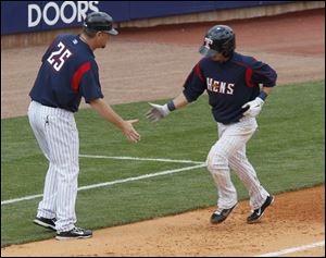 Hen coach Phil Nevin, left, congratulates Will Rhymes as he heads home after hitting his first home run of the season. 