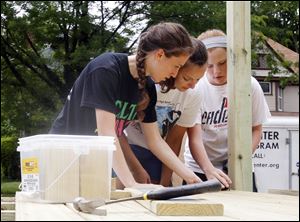 Kait Eisenberg of Chicago, Katherine Paydo of Wadsworth, Ohio, and Sarah Bitner, of Anderson, Ind., from left, are among 300 teens in the Toledo area this week for Catholic H.E.A.R.T. Workcamp projects.