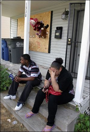 Montelle Taylor’s father, Michael C. Taylor II, and his girlfriend, Mary Taylor, reflect as they sit on the porch of the house where Montelle lived.