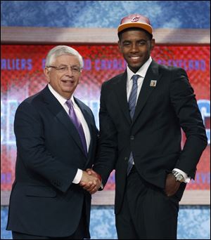 NBA commissioner David Stern congratulates the newest Cleveland Cavalier, Kyrie Irving. He was selected as the No. 1 pick overall.