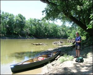 John Jaeger, left, and Lou Hebert finish the final strokes into Antwerp Park Tuesday to  complete the first leg of their 130-mile 'Fort-to-Port' canoe trip.