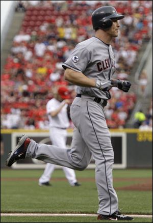 Grady Sizemore, foreground, rounds the bases after hitting a solo home run off Cincinnati Reds starting pitcher Bronson Arroyo, background left, in the second inning.